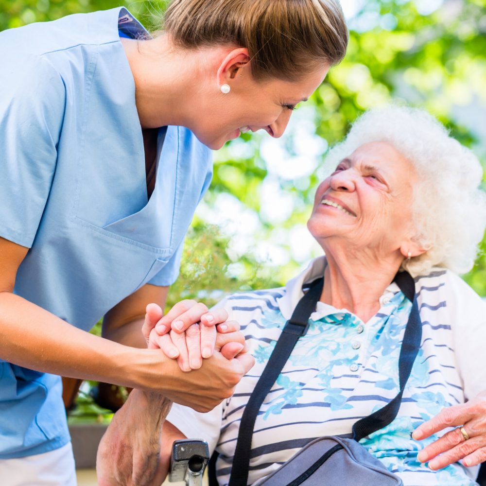 Nurse holding hand of senior woman in pension home Nurse holding hand of senior woman in pension home